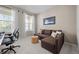 Well-lit office space with an L shaped couch and desk at 827 Sundance Ln, Erie, CO 80516
