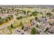 Aerial view of home within community with mature trees and landscaping at 8008 W Spanish Peak, Littleton, CO 80127