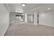 Unfinished basement with neutral carpet, white walls, with sliding door leading to the outside at 8008 W Spanish Peak, Littleton, CO 80127