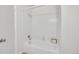 Clean, well-lit bathroom with a tub and shower, offering functionality and a minimalist aesthetic at 8008 W Spanish Peak, Littleton, CO 80127