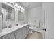 Bright bathroom with dual sinks, updated vanity, and a large mirror with vanity lighting at 8008 W Spanish Peak, Littleton, CO 80127