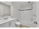White bathroom featuring a bath/shower combination, and a clean white vanity and fixtures at 8008 W Spanish Peak, Littleton, CO 80127