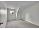 Bright bedroom with a slanted ceiling and neutral carpet creates a cozy and adaptable space at 8008 W Spanish Peak, Littleton, CO 80127