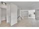 Bright entryway and living space featuring wood-look flooring, leading to the kitchen and staircase at 8008 W Spanish Peak, Littleton, CO 80127