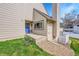 Inviting front entrance with blue door and colorful flower bed at 8008 W Spanish Peak, Littleton, CO 80127