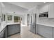 Bright kitchen with stainless steel appliances, quartz counters, and a sliding door to outside at 8008 W Spanish Peak, Littleton, CO 80127