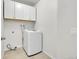 Functional laundry area with white cabinets and a modern washing machine, optimizing space and utility at 8008 W Spanish Peak, Littleton, CO 80127