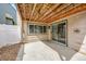 Back patio featuring concrete flooring, privacy fence, and wood ceiling at 8008 W Spanish Peak, Littleton, CO 80127