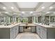 Spacious bathroom with double sinks, grey cabinets, decorative tile flooring and ample lighting at 19061 Eagle Ridge Dr, Golden, CO 80401