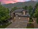 Stunning two-story home with a stone facade and a three-car garage, nestled against a scenic mountain backdrop at 19061 Eagle Ridge Dr, Golden, CO 80401