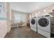 Spacious laundry room with updated machines, ample storage, and natural light from a large window at 19061 Eagle Ridge Dr, Golden, CO 80401