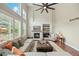 Bright living room featuring a cozy fireplace, high ceilings, and an oversized ceiling fan at 19061 Eagle Ridge Dr, Golden, CO 80401
