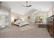 Bright main bedroom featuring vaulted ceilings, a king bed with ensuite bathroom at 19061 Eagle Ridge Dr, Golden, CO 80401