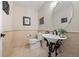 Chic powder room with elegant pedestal sink, stylish fixtures, and tastefully decorated walls at 19061 Eagle Ridge Dr, Golden, CO 80401