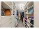 Walk-in closet with custom shelving, storage drawers, a carpeted floor and a decorative chandelier at 19061 Eagle Ridge Dr, Golden, CO 80401