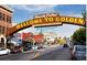 Welcome to Golden sign over a street with brick buildings and parked cars on a sunny day at 19061 Eagle Ridge Dr, Golden, CO 80401