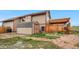 View of the private backyard with a deck, tool shed, and a stone pathway surrounded by mature landscaping at 7507 Halleys Dr, Littleton, CO 80125