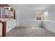 Bright basement featuring carpeted floors and natural light from a large window, creating a versatile space at 7507 Halleys Dr, Littleton, CO 80125