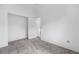 A clean bedroom offers neutral carpet, bright white walls, and a closet with a modern door at 7507 Halleys Dr, Littleton, CO 80125