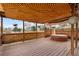 Enjoy a luxurious covered deck with wood floors, lattice ceiling, and hot tub for ultimate relaxation at 7507 Halleys Dr, Littleton, CO 80125
