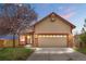 Charming single-Gathering home featuring a two-car garage, brick accents, and a beautifully landscaped front yard at 7507 Halleys Dr, Littleton, CO 80125