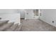Inviting living area with neutral carpet, a window for natural light, and steps leading upwards at 7507 Halleys Dr, Littleton, CO 80125