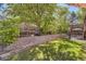 Beautiful backyard with a tiered retaining wall, lush greenery, and a shaded seating area at 10703 Flagler Dr, Parker, CO 80134