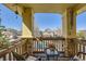 Inviting balcony seating area, perfect for relaxation, with decorative stone pillars and charming neighborhood views at 10703 Flagler Dr, Parker, CO 80134