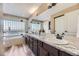Bright bathroom featuring granite countertops, vanity with double sinks, a soaking tub, and a glass shower at 10703 Flagler Dr, Parker, CO 80134