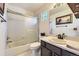 Bright bathroom featuring a tub-shower combo and a vanity with a sink and a large mirror at 10703 Flagler Dr, Parker, CO 80134