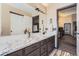 Elegant bathroom featuring granite countertops, a vanity with a sink, and a decorative mirror at 10703 Flagler Dr, Parker, CO 80134