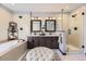 Elegant bathroom featuring double sinks, a soaking tub, a glass shower, and sleek fixtures at 10703 Flagler Dr, Parker, CO 80134