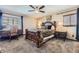 Cozy bedroom featuring carpet flooring, a ceiling fan, and lots of natural light from the window at 10703 Flagler Dr, Parker, CO 80134