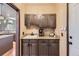 Convenient butler's pantry featuring granite countertops, sink, cabinetry, and coffee station at 10703 Flagler Dr, Parker, CO 80134