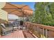 Outdoor deck with comfortable seating, a grill, and an umbrella, ideal for barbecues and relaxation at 10703 Flagler Dr, Parker, CO 80134