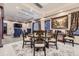 Elegant dining room showcasing a large wooden table, designer chairs, a large painting, and sophisticated decor at 10703 Flagler Dr, Parker, CO 80134