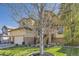 Beautiful home with a well-manicured lawn, fountain, and mature tree in the front yard at 10703 Flagler Dr, Parker, CO 80134