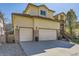 Spacious three car garage with stone accents, coach lights and mature landscaping at 10703 Flagler Dr, Parker, CO 80134