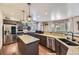 Open concept kitchen features stainless steel appliances, granite counters and dark wood cabinetry at 10703 Flagler Dr, Parker, CO 80134