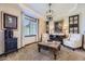 Cozy living room featuring elegant furnishings, a decorative chandelier, and natural light at 10703 Flagler Dr, Parker, CO 80134