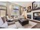 Stylish living room featuring a cozy fireplace, comfortable seating and natural light at 10703 Flagler Dr, Parker, CO 80134