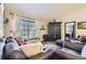 Inviting living room featuring comfortable leather furniture, carpet flooring, and natural light at 10703 Flagler Dr, Parker, CO 80134
