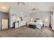 Bright main bedroom featuring a ceiling fan, carpet flooring, ensuite bathroom, and a mini fridge at 10703 Flagler Dr, Parker, CO 80134