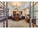 Well-lit home office featuring custom bookshelves, a large desk, and comfortable seating at 10703 Flagler Dr, Parker, CO 80134