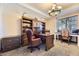 Bright office with a large desk, custom shelves and cabinetry, and natural light at 10703 Flagler Dr, Parker, CO 80134