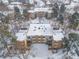 Aerial shot of a multi-Gathering complex with snow-covered roofs, courtyards, and surrounding bare trees at 2835 S Monaco Pkwy # 4-103, Denver, CO 80222