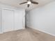 Bedroom with a large closet, neutral carpet, and fresh paint throughout, awaiting personalization at 2835 S Monaco Pkwy # 4-103, Denver, CO 80222