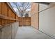 Enclosed patio features a privacy fence and brick wall creating a cozy outdoor space at 2835 S Monaco Pkwy # 4-103, Denver, CO 80222