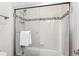 Clean bathroom with a shower/tub combo and tile surround at 9167 E 35Th Ave, Denver, CO 80238