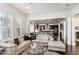 Open living room featuring a light beige sectional sofa and a modern glass coffee table at 9167 E 35Th Ave, Denver, CO 80238